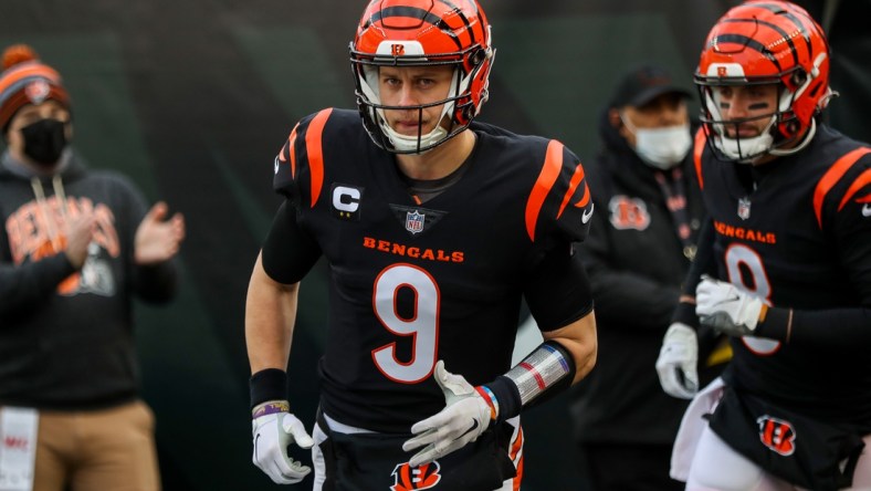 Jan 15, 2022; Cincinnati, Ohio, USA; Cincinnati Bengals quarterback Joe Burrow (9) runs onto the field prior to the game against the Las Vegas Raiders in an AFC Wild Card playoff football game at Paul Brown Stadium. Mandatory Credit: Katie Stratman-USA TODAY Sports