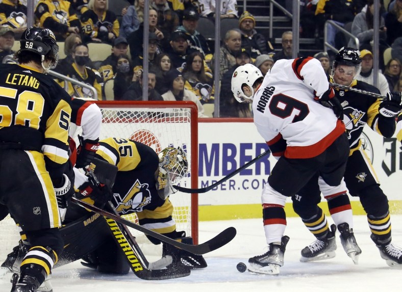 eJan 20, 2022; Pittsburgh, Pennsylvania, USA;  Pittsburgh Penguins goaltender Tristan Jarry (35) makes a save against Ottawa Senators center Josh Norris (9) during the first period at PPG Paints Arena. Mandatory Credit: Charles LeClaire-USA TODAY Sports