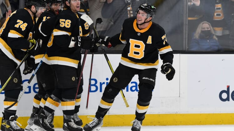 Jan 20, 2022; Boston, Massachusetts, USA; Boston Bruins defenseman Charlie McAvoy (73) celebrates with his teammates after scoring against the Washington Capitals during the third period at the TD Garden. Mandatory Credit: Brian Fluharty-USA TODAY Sports