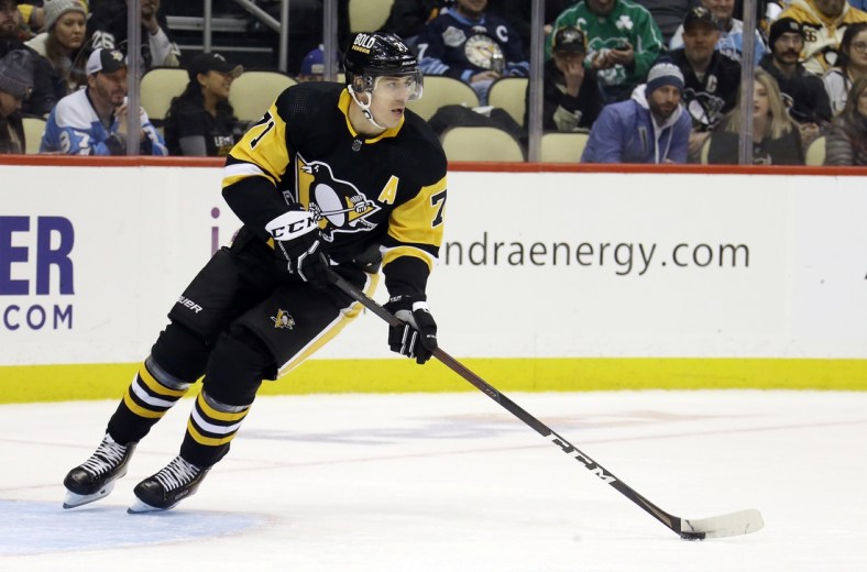Jan 20, 2022; Pittsburgh, Pennsylvania, USA;  Pittsburgh Penguins center Evgeni Malkin (71) handles the puck against the Ottawa Senators during the third period at PPG Paints Arena. The Penguins won 6-4. Mandatory Credit: Charles LeClaire-USA TODAY Sports