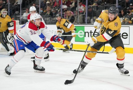 Jan 20, 2022; Las Vegas, Nevada, USA;Vegas Golden Knights defenseman Brayden McNabb (3) clears the puck against the slash of Montreal Canadiens center Rem Pitlick (32) during the first period at T-Mobile Arena. Mandatory Credit: Stephen R. Sylvanie-USA TODAY Sports