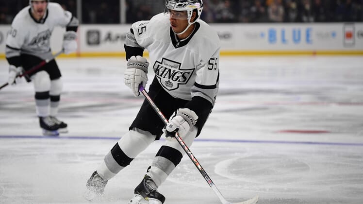 Jan 20, 2022; Los Angeles, California, USA; Los Angeles Kings center Quinton Byfield (55) controls the puck against the Colorado Avalanche during the second period at Crypto.com Arena. Mandatory Credit: Gary A. Vasquez-USA TODAY Sports