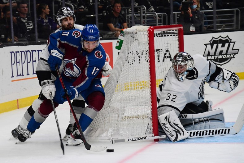 Jan 20, 2022; Los Angeles, California, USA; Colorado Avalanche center Tyson Jost (17) moves in for a shot on goal against Los Angeles Kings goaltender Jonathan Quick (32) and center Phillip Danault (24) during the third period at Crypto.com Arena. Mandatory Credit: Gary A. Vasquez-USA TODAY Sports