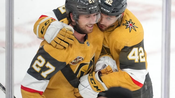 Jan 20, 2022; Las Vegas, Nevada, USA; Vegas Golden Knights defenseman Shea Theodore (27) is embraced by forward Daniil Miromanov (42) after scoring the game winning goal against the Montreal Canadiens for a 4-3 victory at T-Mobile Arena. Mandatory Credit: Stephen R. Sylvanie-USA TODAY Sports