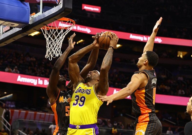 Jan 21, 2022; Orlando, Florida, USA; Orlando Magic center Mo Bamba (5) and guard Jalen Suggs (4) defend Los Angeles Lakers center Dwight Howard (39) shot  during the first quarter at Amway Center. Mandatory Credit: Kim Klement-USA TODAY Sports