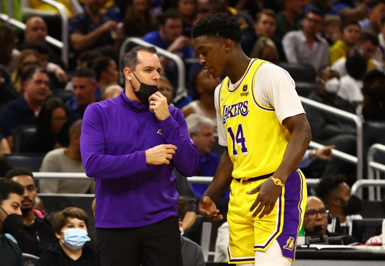 Jan 21, 2022; Orlando, Florida, USA;  Los Angeles Lakers head coach Frank Vogel talks with forward Stanley Johnson (14) during the first quarter against the Orlando Magic at Amway Center. Mandatory Credit: Kim Klement-USA TODAY Sports