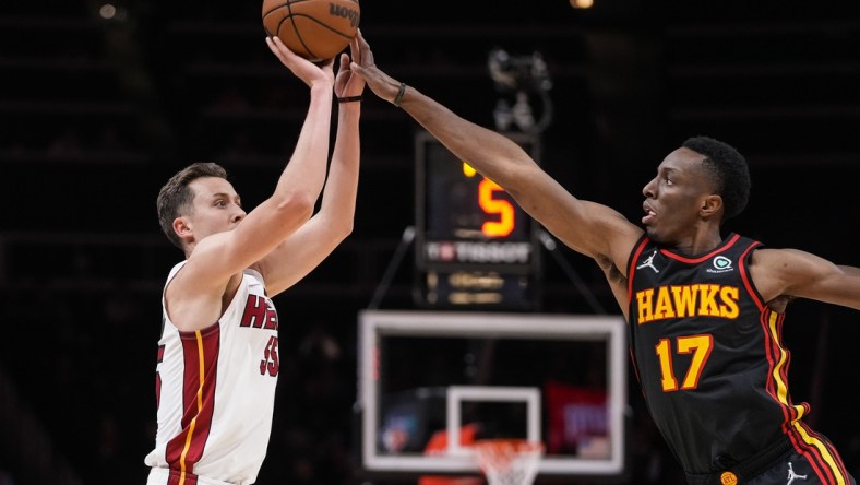 Jan 21, 2022; Atlanta, Georgia, USA; Miami Heat guard Duncan Robinson (55) is fouled while shooting by Atlanta Hawks forward Onyeka Okongwu (17) during the first half at State Farm Arena. Mandatory Credit: Dale Zanine-USA TODAY Sports