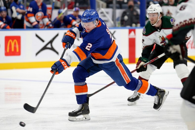 Jan 21, 2022; Elmont, New York, USA; New York Islanders defenseman Robin Salo (2) shoots against Arizona Coyotes right wing Christian Fischer (36) during the second period at UBS Arena. Mandatory Credit: Brad Penner-USA TODAY Sports