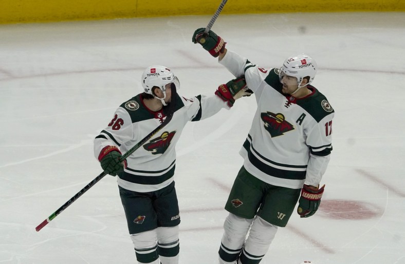 Jan 21, 2022; Chicago, Illinois, USA; Minnesota Wild left wing Marcus Foligno (17) celebrates his goal against the Chicago Blackhawks with right wing Mats Zuccarello (36) during the first period at United Center. Mandatory Credit: David Banks-USA TODAY Sports