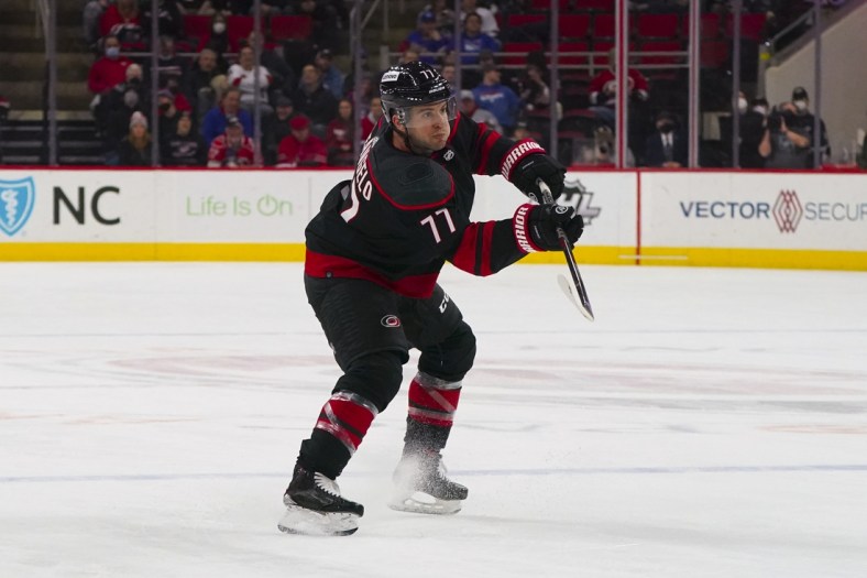 Jan 21, 2022; Raleigh, North Carolina, USA;  Carolina Hurricanes defenseman Tony DeAngelo (77) scores a goal against the New York Rangers during the third period at PNC Arena. Mandatory Credit: James Guillory-USA TODAY Sports