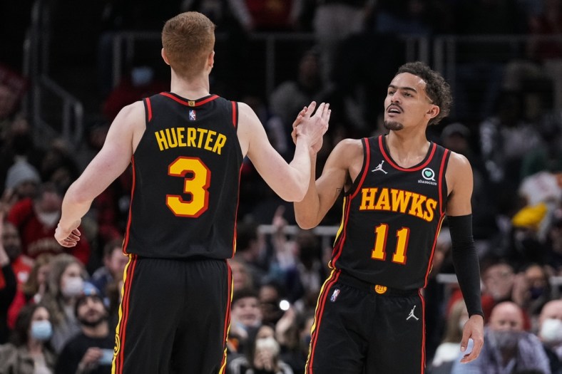 Jan 21, 2022; Atlanta, Georgia, USA; Atlanta Hawks guard Kevin Huerter (3) reacts with guard Trae Young (11) after making a three point shot against the Miami Heat during the second half at State Farm Arena. Mandatory Credit: Dale Zanine-USA TODAY Sports