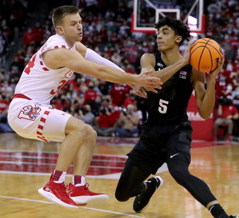 Wisconsin guard Brad Davison (34) pressures Michigan State guard Max Christie (5) during the first half of their game at the Kohl Center Friday, January 21, 2022 in Madison, Wis. Michigan State beat Wisconsin 86-74.Uwmen22 14