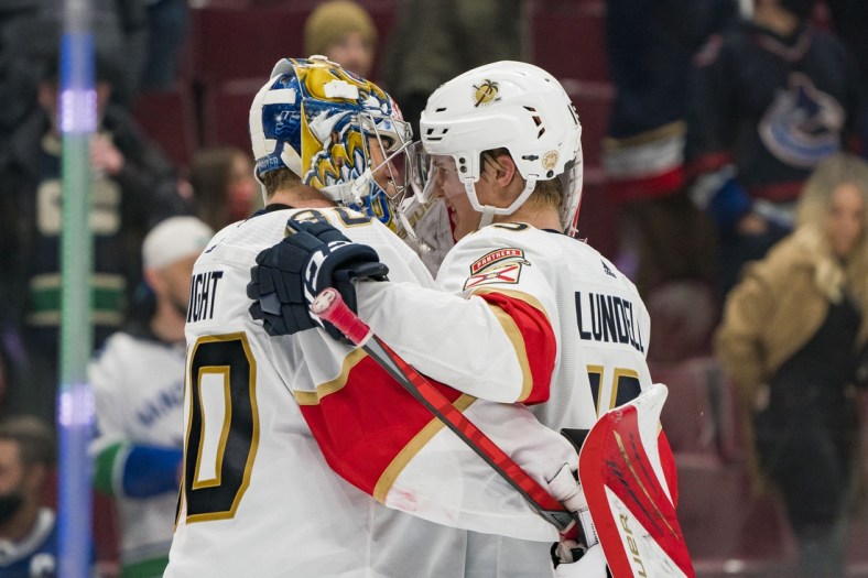 Jan 21, 2022; Vancouver, British Columbia, CAN; Florida Panthers goalie Spencer Knight (30) and forward Anton Lundell (15) celebrate their victory against the Vancouver Canucks at Rogers Arena. Florida won 2-1 in a shootout. Mandatory Credit: Bob Frid-USA TODAY Sports