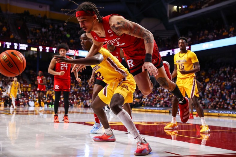 Jan 22, 2022; Minneapolis, Minnesota, USA; Minnesota Gophers guard Abdoulaye Thiam (2) and Rutgers Scarlet Knights guard Caleb McConnell (22) attempt to keep the ball in bounds during the first half at Williams Arena. Mandatory Credit: Harrison Barden-USA TODAY Sports