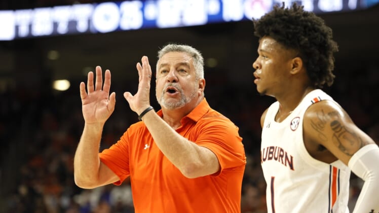 Jan 22, 2022; Auburn, Alabama, USA;  Auburn Tigers head coach Bruce Pearl talks to guard Wendell Green Jr. (1) during a time out in the first half against the Kentucky Wildcats at Auburn Arena. Mandatory Credit: John Reed-USA TODAY Sports
