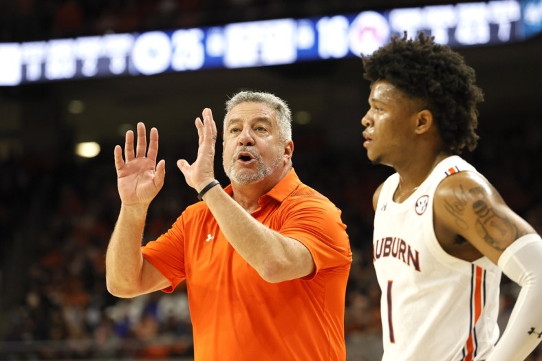 Jan 22, 2022; Auburn, Alabama, USA;  Auburn Tigers head coach Bruce Pearl talks to guard Wendell Green Jr. (1) during a time out in the first half against the Kentucky Wildcats at Auburn Arena. Mandatory Credit: John Reed-USA TODAY Sports