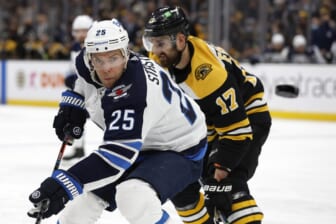 Jan 22, 2022; Boston, Massachusetts, USA; Winnipeg Jets center Paul Stastny (25) eyes a loose puck as Boston Bruins left wing Nick Foligno (17) skates by during the second period at TD Garden. Mandatory Credit: Winslow Townson-USA TODAY Sports