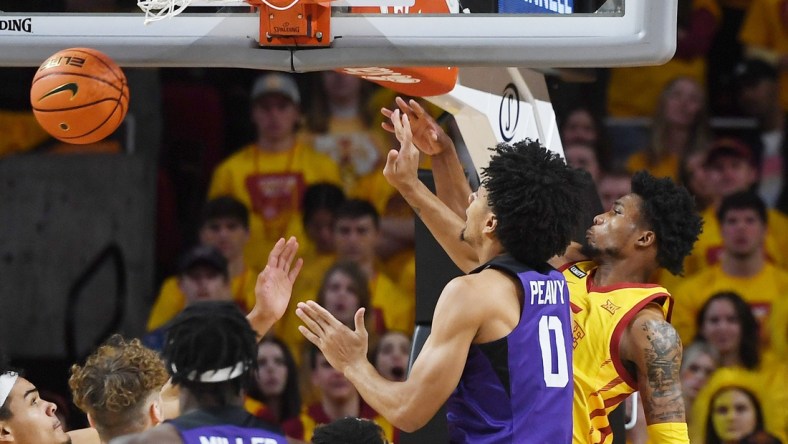 Iowa State Cyclones guard Tyrese Hunter (11) knocks the ball out from TCU Horned Frogs guard Micah Peavy (0)  as he drives to the basket during the first half at Hilton Coliseum Saturday, Jan. 22, 2022, in Ames, Iowa.