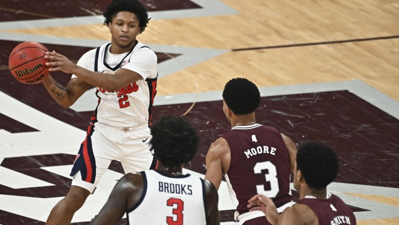 Jan 22, 2022; Starkville, Mississippi, USA;Mississippi Rebels guard Daeshun Ruffin (2) handles the ball while defended by Mississippi State Bulldogs guard Shakeel Moore (3) during the first half at Humphrey Coliseum. Mandatory Credit: Matt Bush-USA TODAY Sports