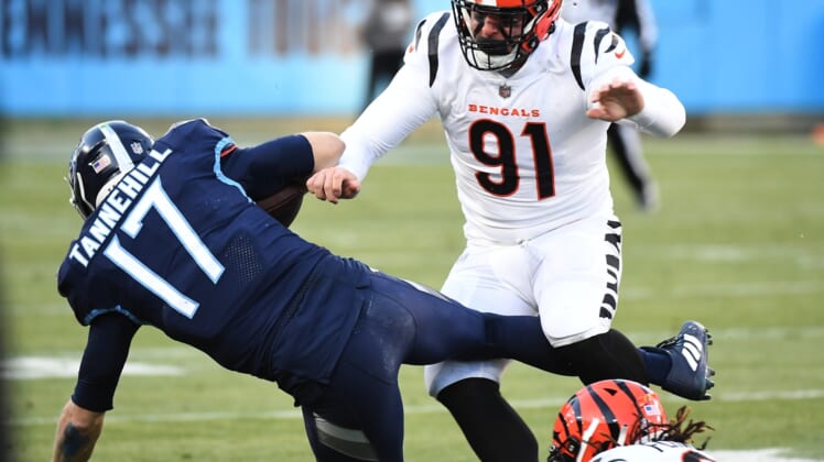 Jan 22, 2022; Nashville, Tennessee, USA; Tennessee Titans quarterback Ryan Tannehill (17) is tackled by Cincinnati Bengals defensive end Trey Hendrickson (91) during the first half of an AFC Divisional playoff football game at Nissan Stadium. Mandatory Credit: Christopher Hanewinckel-USA TODAY Sports