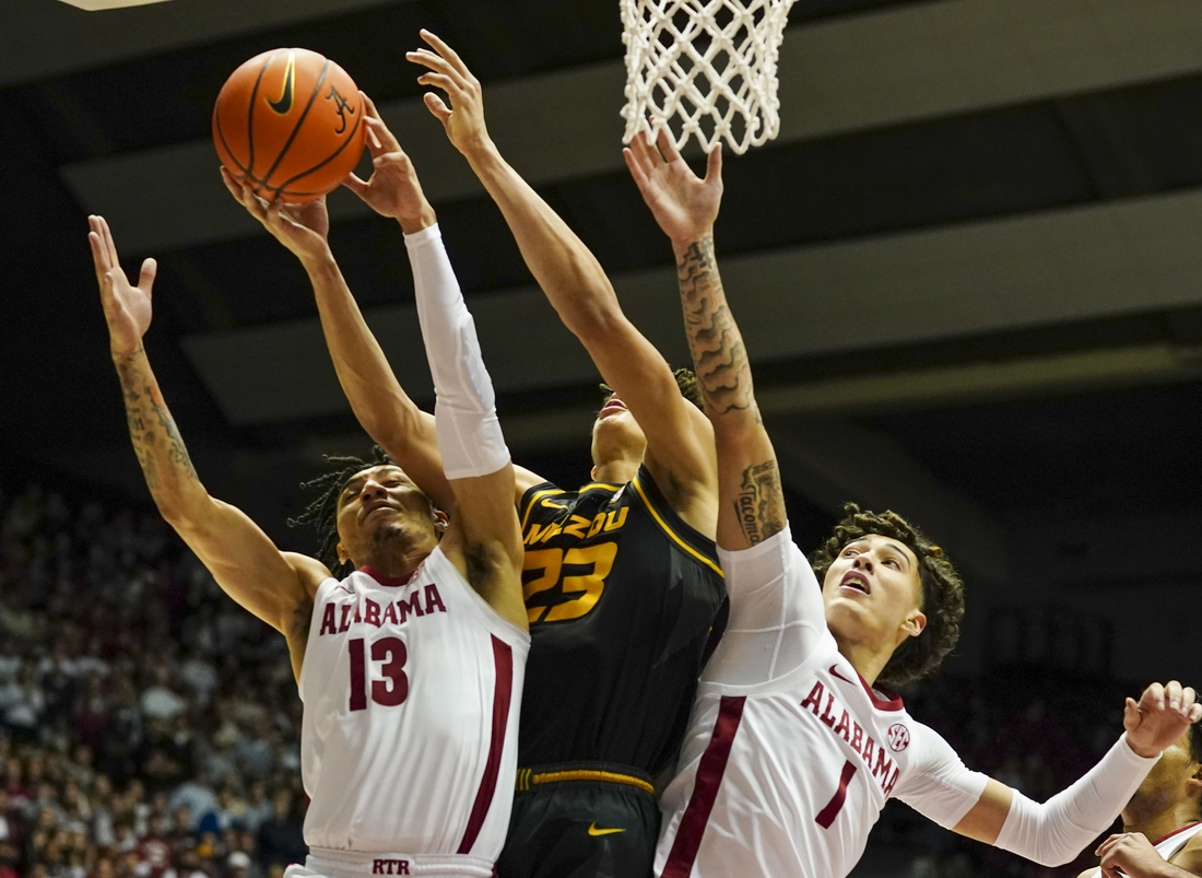 Jan 22, 2022; Tuscaloosa, Alabama, USA; Missouri Tigers forward Trevon Brazile (23) goes for the rebound along with Alabama Crimson Tide guard Jahvon Quinerly (13) and Alabama Crimson Tide guard Jusaun Holt (1) during the first half at Coleman Coliseum. Mandatory Credit: Marvin Gentry-USA TODAY Sports