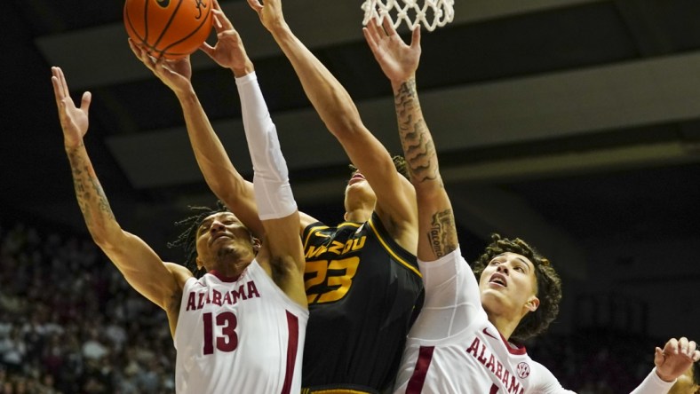 Jan 22, 2022; Tuscaloosa, Alabama, USA; Missouri Tigers forward Trevon Brazile (23) goes for the rebound along with Alabama Crimson Tide guard Jahvon Quinerly (13) and Alabama Crimson Tide guard Jusaun Holt (1) during the first half at Coleman Coliseum. Mandatory Credit: Marvin Gentry-USA TODAY Sports