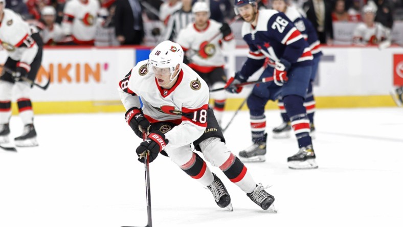 Jan 22, 2022; Washington, District of Columbia, USA; Ottawa Senators left wing Tim Stutzle (18) skates with the puck as Washington Capitals center Nic Dowd (26) chases during the second period at Capital One Arena. Mandatory Credit: Geoff Burke-USA TODAY Sports