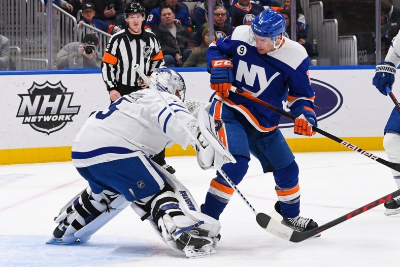 Jan 22, 2022; Elmont, New York, USA;  Toronto Maple Leafs goaltender Petr Mrazek (35) makes a save on New York Islanders left wing Zach Parise (11) during the second period at UBS Arena. Mandatory Credit: Dennis Schneidler-USA TODAY Sports