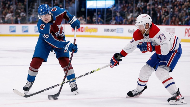 Jan 22, 2022; Denver, Colorado, USA; Colorado Avalanche right wing Nicolas Aube-Kubel (16) takes a shot as Montreal Canadiens defenseman Brett Kulak (77) defends in the second period at Ball Arena. Mandatory Credit: Isaiah J. Downing-USA TODAY Sports