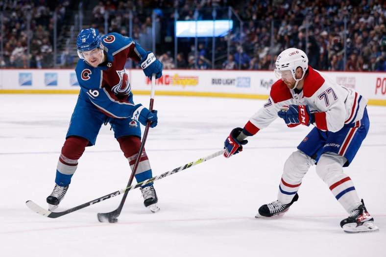 Jan 22, 2022; Denver, Colorado, USA; Colorado Avalanche right wing Nicolas Aube-Kubel (16) takes a shot as Montreal Canadiens defenseman Brett Kulak (77) defends in the second period at Ball Arena. Mandatory Credit: Isaiah J. Downing-USA TODAY Sports
