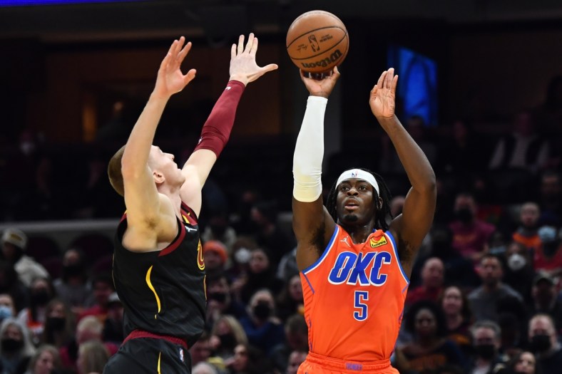 Jan 22, 2022; Cleveland, Ohio, USA; Oklahoma City Thunder forward Luguentz Dort (5) shoots over Cleveland Cavaliers guard Dylan Windler (9) during the first half at Rocket Mortgage FieldHouse. Mandatory Credit: Ken Blaze-USA TODAY Sports