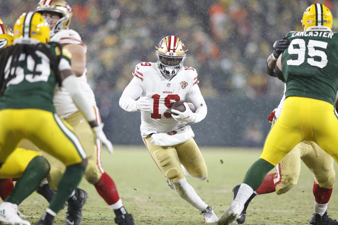 Jan 22, 2022; Green Bay, Wisconsin, USA; San Francisco 49ers wide receiver Deebo Samuel (19) carries the ball in the third quarter against the Green Bay Packers during a NFC Divisional playoff football game at Lambeau Field. Mandatory Credit: Jeff Hanisch-USA TODAY Sports