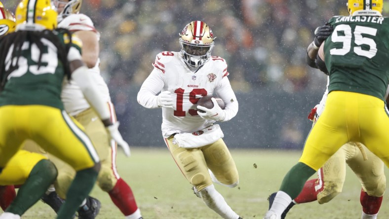 Jan 22, 2022; Green Bay, Wisconsin, USA; San Francisco 49ers wide receiver Deebo Samuel (19) carries the ball in the third quarter against the Green Bay Packers during a NFC Divisional playoff football game at Lambeau Field. Mandatory Credit: Jeff Hanisch-USA TODAY Sports