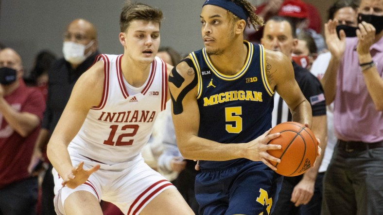 Jan 23, 2022; Bloomington, Indiana, USA; Michigan Wolverines forward Terrance Williams II (5) dribbles the ball while Indiana Hoosiers forward Miller Kopp (12) defends in the first half at Simon Skjodt Assembly Hall. Mandatory Credit: Trevor Ruszkowski-USA TODAY Sports