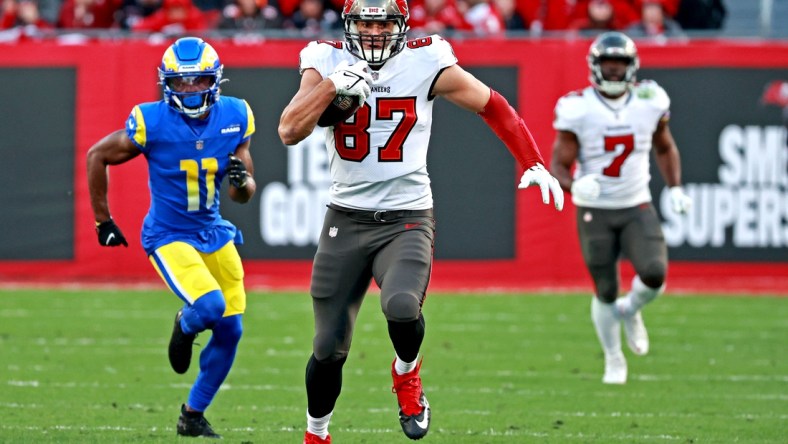 Jan 23, 2022; Tampa, Florida, USA; Tampa Bay Buccaneers tight end Rob Gronkowski (87) runs the ball against Los Angeles Rams cornerback Darious Williams (11) during the second half in a NFC Divisional playoff football game at Raymond James Stadium. Mandatory Credit: Matt Pendleton-USA TODAY Sports