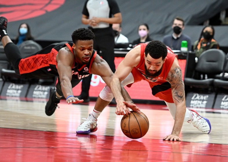 Jan 23, 2022; Toronto, Ontario, CAN;  Portland Trail Blazers guard Dennis Smith Jr. (10) and Toronto Raptors guard Fred VanVleet (23) battle for a loose ball in the second half at Scotiabank Arena. Mandatory Credit: Dan Hamilton-USA TODAY Sports
