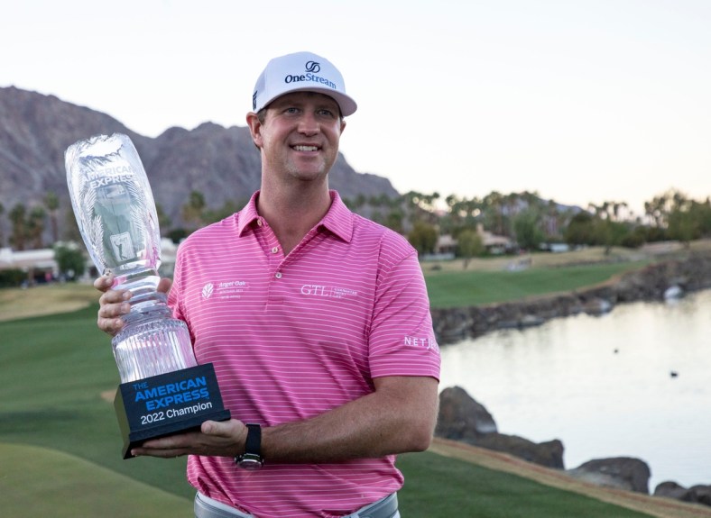 Hudson Swafford holds his trophy on the 18th green of the Pete Dye Stadium course after winning The American Express at PGA West in La Quinta, Calif., Sunday, Jan. 23, 2022.