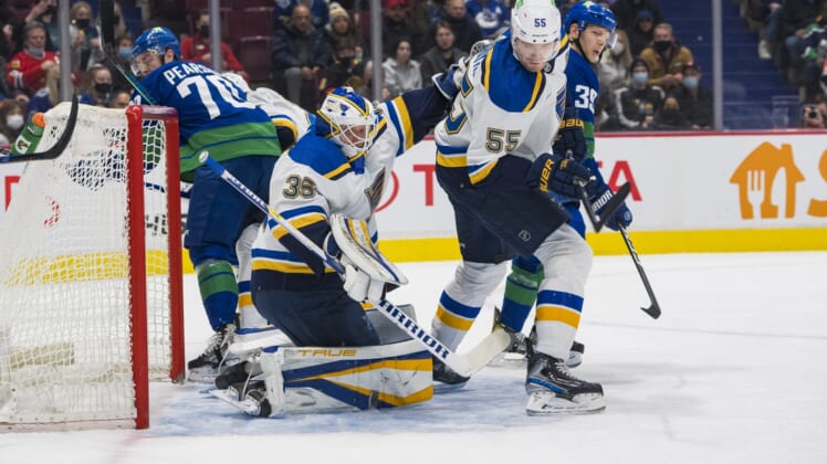 Jan 23, 2022; Vancouver, British Columbia, CAN; St. Louis Blues defenseman Colton Parayko (55) looks on as goalie Ville Husso (35) makes a save against the Vancouver Canucks  in the first period at Rogers Arena. Mandatory Credit: Bob Frid-USA TODAY Sports