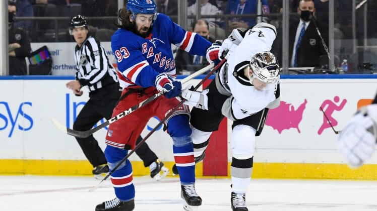 Jan 24, 2022; New York, New York, USA;  New York Rangers center Mika Zibanejad (93) and Los Angeles Kings defenseman Mikey Anderson (44) collide during the first period at Madison Square Garden. Mandatory Credit: Dennis Schneidler-USA TODAY Sports