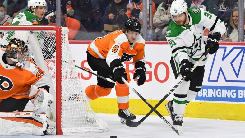 Jan 24, 2022; Philadelphia, Pennsylvania, USA; Dallas Stars center Tyler Seguin (91) passes the puck against Philadelphia Flyers defenseman Travis Sanheim (6) during the first period at Wells Fargo Center. Mandatory Credit: Eric Hartline-USA TODAY Sports