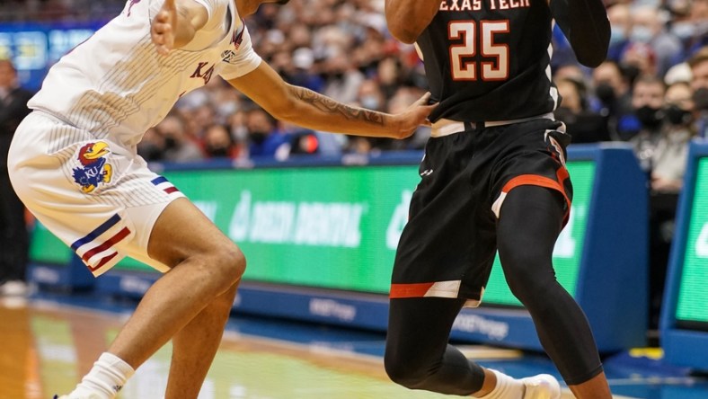 Jan 24, 2022; Lawrence, Kansas, USA; Texas Tech Red Raiders guard Adonis Arms (25) looks to pass as Kansas Jayhawks guard Dajuan Harris Jr. (3) defends during the first half at Allen Fieldhouse. Mandatory Credit: Denny Medley-USA TODAY Sports