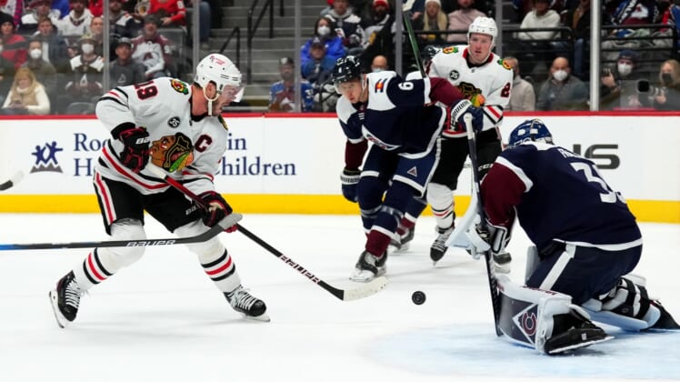 Jan 24, 2022; Denver, Colorado, USA; Chicago Blackhawks center Jonathan Toews (19) attempts to score on Colorado Avalanche goaltender Pavel Francouz (39) in the first period at Ball Arena. Mandatory Credit: Ron Chenoy-USA TODAY Sports