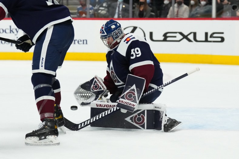 Jan 24, 2022; Denver, Colorado, USA; Colorado Avalanche goaltender Pavel Francouz (39) makes glove save in the first period against the Chicago Blackhawks at Ball Arena. Mandatory Credit: Ron Chenoy-USA TODAY Sports