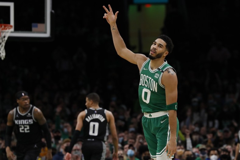 Jan 25, 2022; Boston, Massachusetts, USA; Boston Celtics forward Jayson Tatum (0) holds up three fingers after making a three point basket against the Sacramento Kings during the first quarter at TD Garden. Mandatory Credit: Winslow Townson-USA TODAY Sports