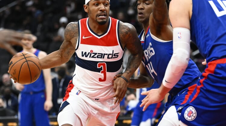 Jan 25, 2022; Washington, District of Columbia, USA; Washington Wizards guard Bradley Beal (3) dribbles as LA Clippers guard Terance Mann (14) defends during the first half at Capital One Arena. Mandatory Credit: Brad Mills-USA TODAY Sports