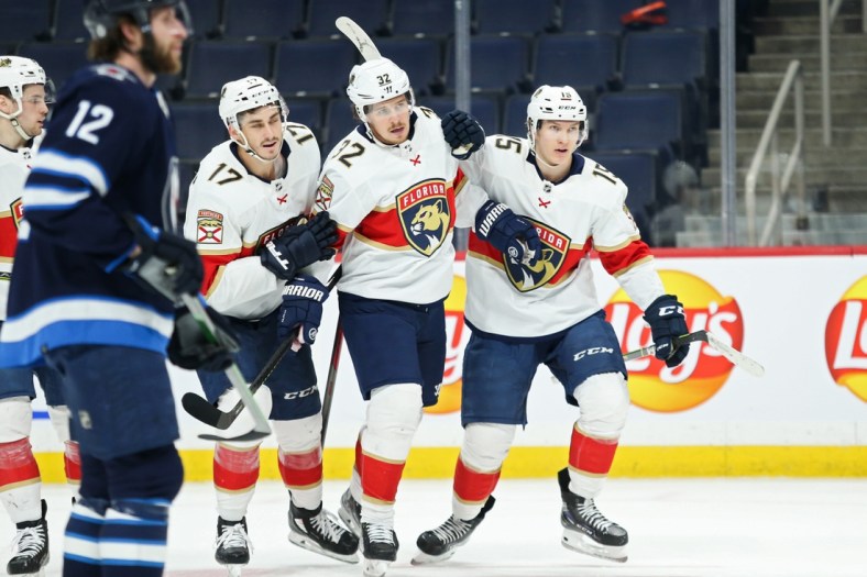Jan 25, 2022; Winnipeg, Manitoba, CAN; Florida Panthers forward Anton Lundell (15) is congratulated by teammates after scoring a goal against the Winnipeg Jets during the first period at Canada Life Centre. Mandatory Credit: Terrence Lee-USA TODAY Sports