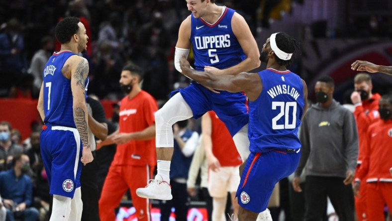 Jan 25, 2022; Washington, District of Columbia, USA; LA Clippers guard Luke Kennard (5) reacts after making a three-point basket while being fouled late in the fourth quarter against the Washington Wizards at Capital One Arena. Kennard would make the free-throw to take a one point lead with 1.9 seconds left in the game. Mandatory Credit: Brad Mills-USA TODAY Sports