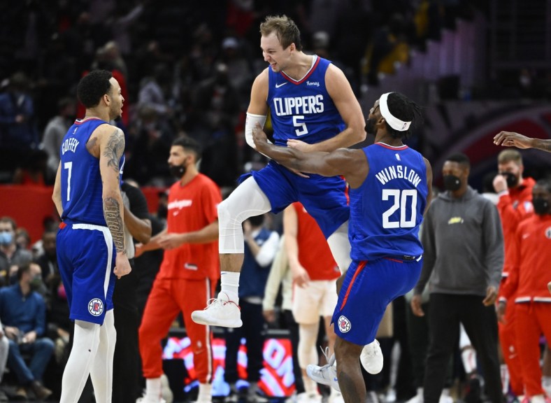 Jan 25, 2022; Washington, District of Columbia, USA; LA Clippers guard Luke Kennard (5) reacts after making a three-point basket while being fouled late in the fourth quarter against the Washington Wizards at Capital One Arena. Kennard would make the free-throw to take a one point lead with 1.9 seconds left in the game. Mandatory Credit: Brad Mills-USA TODAY Sports