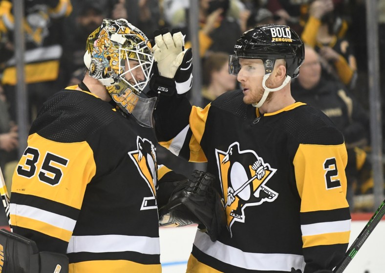 Jan 25, 2022; Pittsburgh, Pennsylvania, USA;  Pittsburgh Penguins goalie Tristan Jarry (35) is congratulated by defenseman Chad Ruhwedel (2) after defeating the Arizona Coyotes 6-3 at PPG Paints Arena. The Penguins won 6-3.  Mandatory Credit: Philip G. Pavely-USA TODAY Sports
