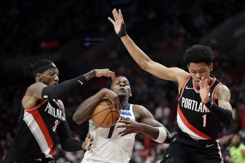 Jan 25, 2022; Portland, Oregon, USA; Minnesota Timberwolves small forward Anthony Edwards (1) is fouled as he drives to the basket by Portland Trail Blazers power forward Robert Covington (33) during the first half  at Moda Center. Mandatory Credit: Soobum Im-USA TODAY Sports